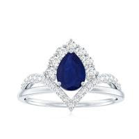 Pear cut blue sapphire solitaire ring with diamond accent, crafted by Rosec Jewels, showcasing the elegant design and sparkling gemstones.