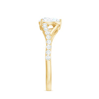 Pear cut moissanite engagement ring with split shank design from Rosec Jewels, showcasing a sparkling gemstone and elegant band.