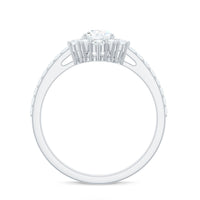 Moissanite teardrop engagement ring with half halo by Rosec Jewels, showcasing a sparkling teardrop-shaped gemstone and intricate band.