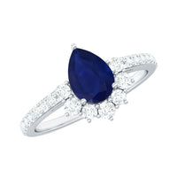 Pear-shaped blue sapphire and diamond half halo engagement ring by Rosec Jewels, featuring intricate band detail and sparkling stones.