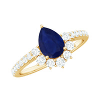 Pear-shaped blue sapphire and diamond half halo engagement ring by Rosec Jewels, showcasing intricate detail and sparkling gemstones.