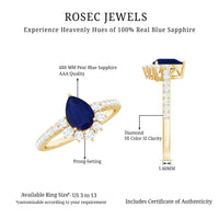 Pear-shaped blue sapphire and diamond half halo engagement ring featuring a 0.5 carat center stone, set in a Rosec Jewels ring.