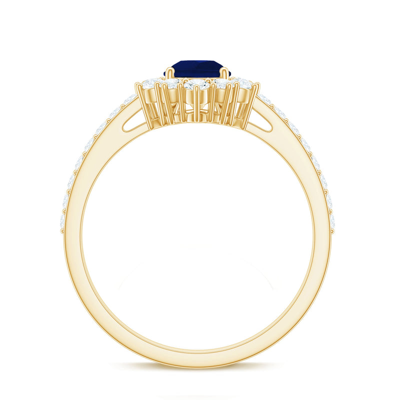 Pear-shaped blue sapphire and diamond half halo engagement ring from Rosec Jewels with 0.5 carat center stone.