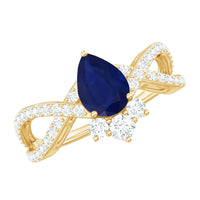 Pear-shaped blue sapphire engagement ring with diamond crossover detailing, crafted by Rosec Jewels.