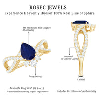 Pear-shaped blue sapphire engagement ring with diamond crossover design by Rosec Jewels, featuring a 0.5 carat sapphire centerpiece.