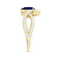 Pear-shaped blue sapphire engagement ring with diamond crossover setting by Rosec Jewels, featuring a real 0.5 carat sapphire and diamonds.