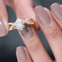 Pear-shaped moissanite crossover engagement ring by Rosec Jewels featuring a unique design and sparkling center stone.