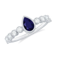 Pear cut 0.5 carat blue sapphire engagement ring with diamonds by Rosec Jewels, showcasing the elegant ring setting.