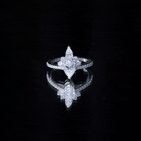 Pear-shaped 0.7 carat Moissanite engagement ring with a crown setting, featuring yellow gold band by Rosec Jewels.