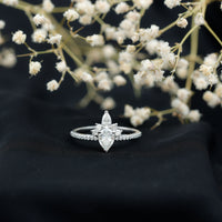 Pear shape 0.7 carat moissanite engagement ring with a crown setting, featuring Rosec Jewels branding and elegant design.