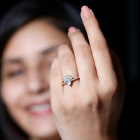 Pear shape 0.7 carat Moissanite engagement ring with a crown setting from Rosec Jewels, showcasing the elegant gemstone and intricate band.
