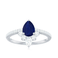 Pear-shaped blue sapphire engagement ring with diamond accents, featuring a crown setting, by Rosec Jewels.