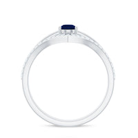 Pear cut blue sapphire solitaire ring set with diamond enhancer band, showcasing elegant blue gemstone and sparkling accents.
