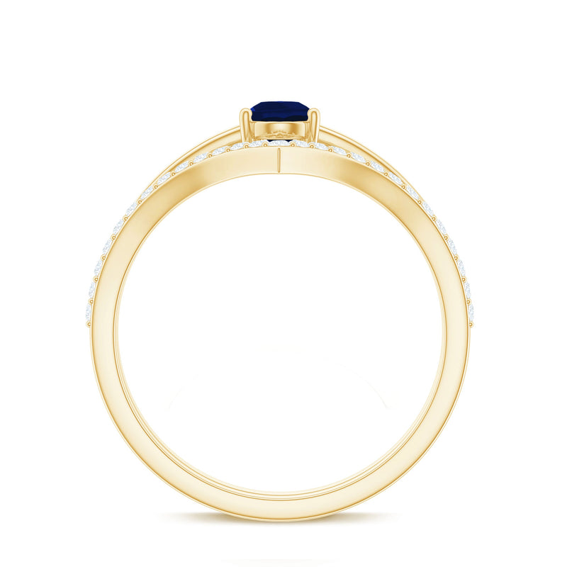 Blue sapphire solitaire ring set with pear-cut gemstone and diamond enhancer band, featuring a Rosec Jewels design.