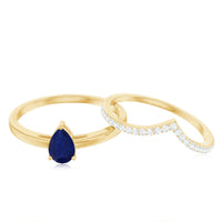 Pear cut blue sapphire solitaire ring set with diamond enhancer band by Rosec Jewels, featuring a blue sapphire and sparkling diamonds.