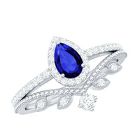 Lab grown blue sapphire pear-shaped engagement ring set with diamonds, featuring elegant silver bands and detailed gemstone setting.