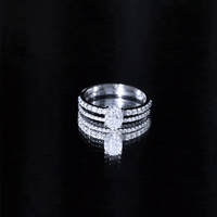Oval-shaped moissanite engagement ring with matching wedding band set from Rosec Jewels, featuring sparkling stone details.