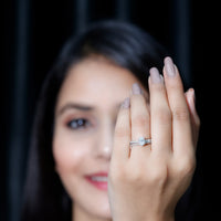 Oval-shaped moissanite engagement ring with matching wedding band set by Rosec Jewels, showcasing sparkling gemstones and elegant design.