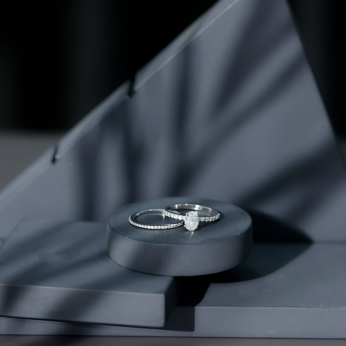 Oval-shaped Moissanite engagement ring with matching wedding band set by Rosec Jewels, showcasing sparkling gemstones and elegant design.