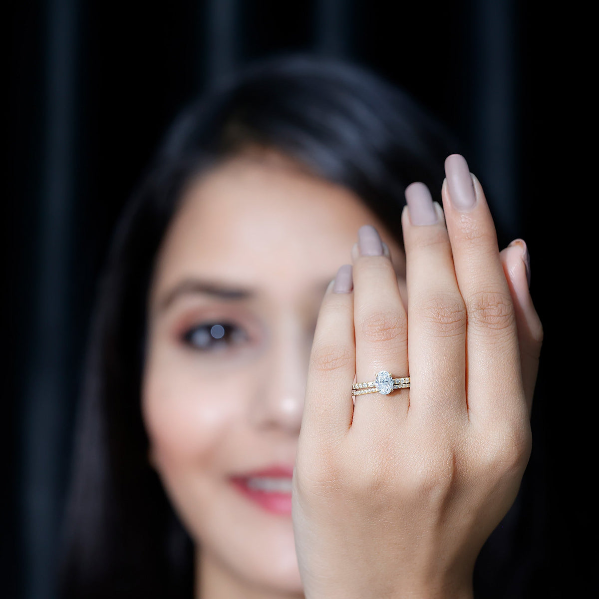 Oval-shaped moissanite engagement ring and wedding band set by Rosec Jewels, featuring sparkling stones and elegant design.