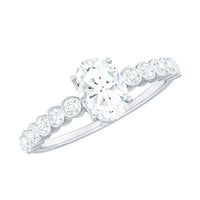 Oval cut moissanite engagement ring with side stones, featuring a sparkling center gem and detailed band design from Rosec Jewels.