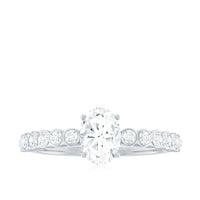 Oval cut Moissanite engagement ring with side stones, featuring a sparkling band and intricate design by Rosec Jewels.
