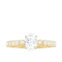 Oval cut moissanite engagement ring with side stones, featuring a polished band and intricate detailing by Rosec Jewels.