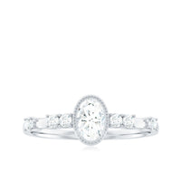 Oval shape zircon solitaire engagement ring with side stones from Rosec Jewels, featuring a sparkling central gemstone and elegant band.