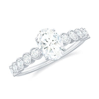 Oval cut Moissanite engagement ring with side stones, featuring a polished band and sparkling gemstone setting by Rosec Jewels.