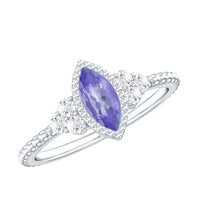 Vintage style marquise tanzanite promise ring with diamond trio from Rosec Jewels, showcasing intricate design and sparkling gemstones.