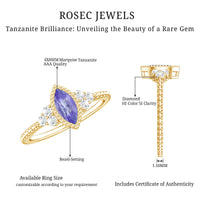 Vintage style marquise tanzanite promise ring with diamond trio accents, featuring a detailed gold band and intricate design.