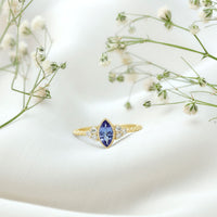 Vintage style marquise tanzanite promise ring with diamond trio from Rosec Jewels, featuring a detailed gold band and elegant design.