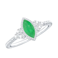 Vintage-inspired emerald engagement ring with trio diamonds from Rosec Jewels, showcasing a detailed gold band and sparkling stones.