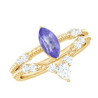Natural marquise Tanzanite diamond engagement ring set with rose gold bands, featuring sparkling stones and intricate detailing.