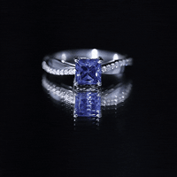 Yellow gold 1.5 carat lab-grown blue sapphire princess cut engagement ring with diamonds by Rosec Jewels.