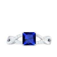Rosec Jewels 1.5 carat lab-grown blue sapphire princess cut engagement ring with diamond crossover shank and elegant metal band.