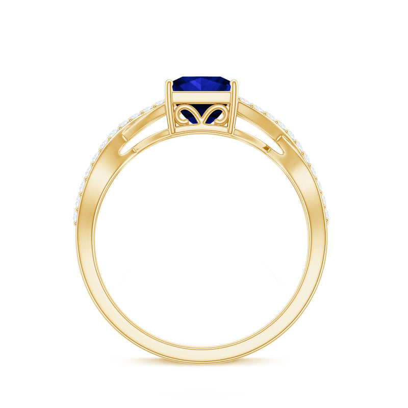 Lab-grown blue sapphire engagement ring with princess cut center stone and diamond crossover shank by Rosec Jewels.