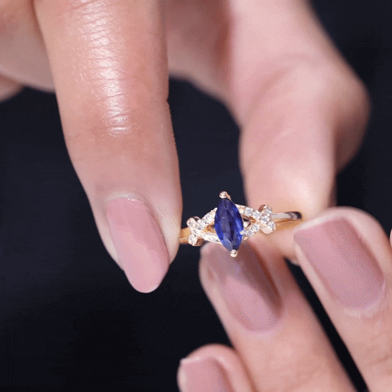 Lab-grown blue sapphire marquise engagement ring with diamonds by Rosec Jewels, featuring a 0.75-carat center gemstone and elegant design.
