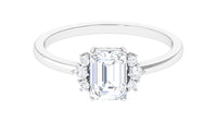 Two-carat octagon cut cubic zirconia solitaire engagement ring with silver band, featuring a sparkling central stone and intricate band design.