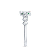 Vintage emerald cut emerald engagement ring with diamond accents from Rosec Jewels, showcasing a detailed gold band and intricate design.
