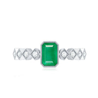 Vintage emerald cut emerald engagement ring with diamond accents from Rosec Jewels, showcasing elegant metal band and detailed craftsmanship.
