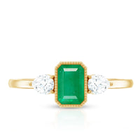 Emerald 3-stone ring with diamonds from Rosec Jewels, showcasing a detailed view of the elegant gemstone and sparkling accents.