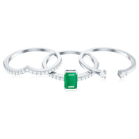 Natural emerald cut emerald and diamond bridal ring set by Rosec Jewels featuring three elegant rings with sparkling stones.