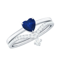 Heart-shaped blue sapphire solitaire wedding ring set with diamond accents, showcasing elegant rose gold bands and detailed craftsmanship.
