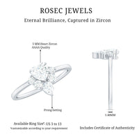 Cubic zirconia heart engagement ring with side stones from Rosec Jewels, featuring a sparkling center heart-shaped stone and elegant design.