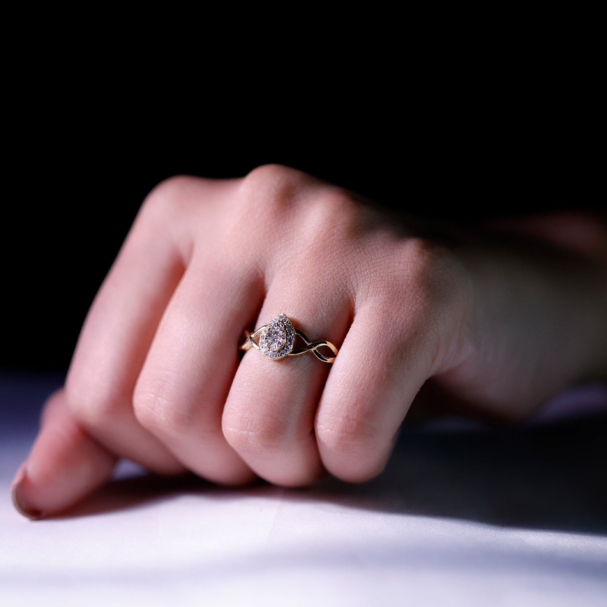 Round moissanite crossover halo engagement ring from Rosec Jewels with a sleek design and sparkling gemstone detail.
