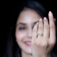 Round Moissanite crossover halo engagement ring from Rosec Jewels with intricate band design and sparkling stones.