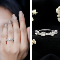 Round moissanite half eternity wedding band by Rosec Jewels, showcasing a sleek silver ring with sparkling stones.