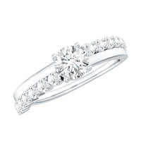 Round cut moissanite engagement ring with side stones, featuring a sparkling center stone and detailed band design.