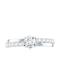Round cut moissanite engagement ring with side stones, featuring a sparkling band and elegant design by Rosec Jewels.